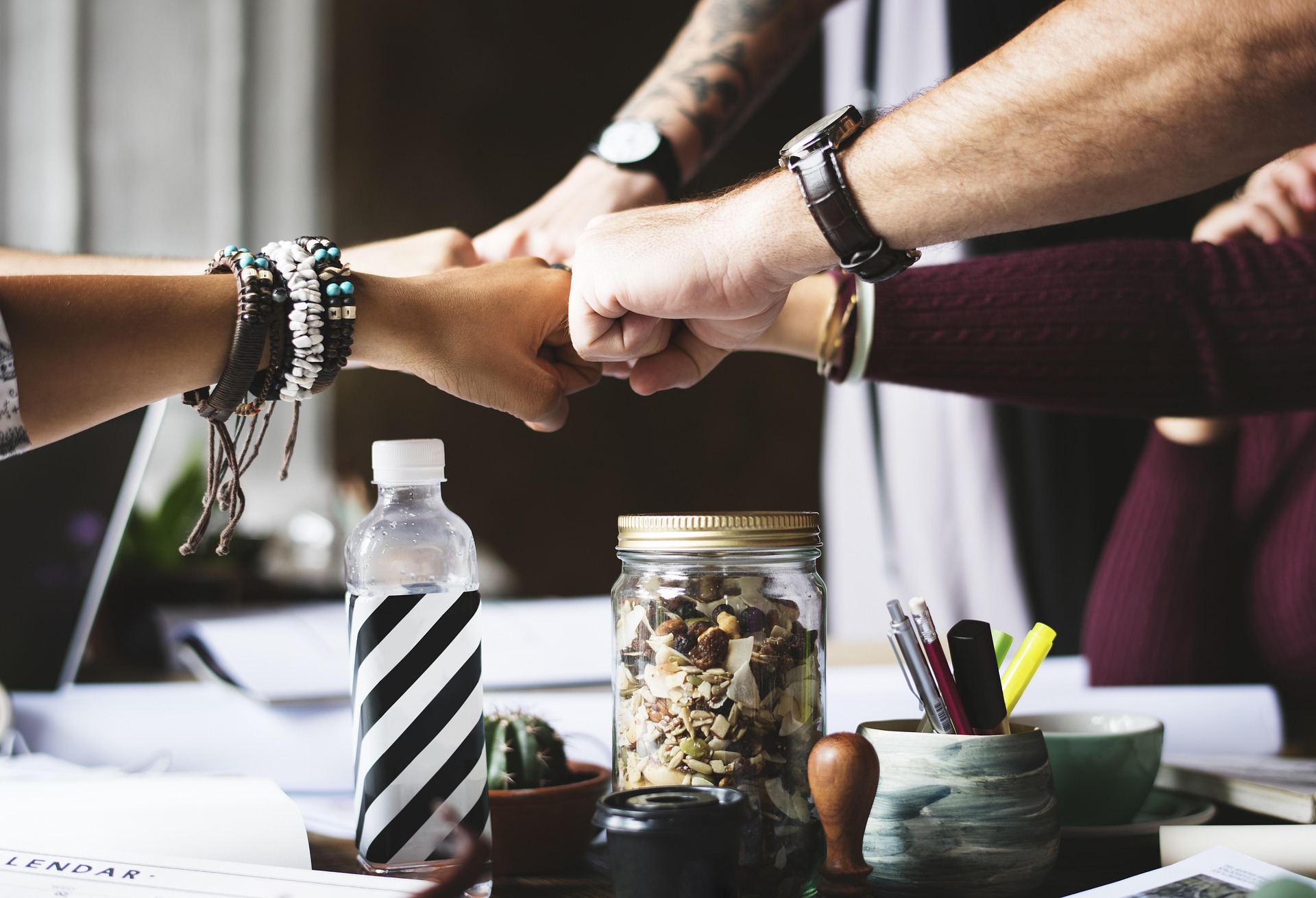Small business team joining hands