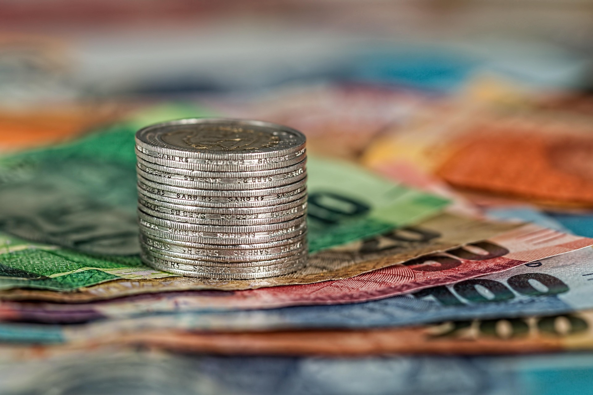 Stacked coins on currency notes